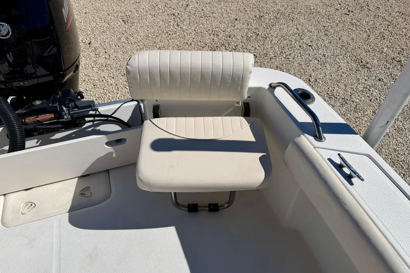 Slide: The Image of 2014 Mako 184 Center Console boat interior with seating and motor detail. - 19