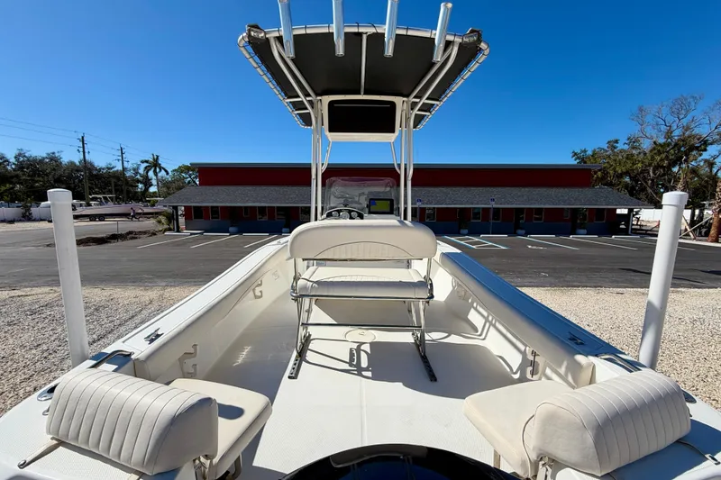 Slide: The Image of 2014 Mako 184 Center Console boat with seating and T-top in a parking lot. - 21