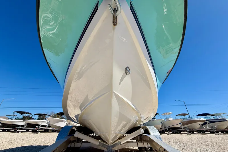 Slide: The Image of 2014 Mako 184 Center Console boat on trailer, viewed from front, under clear blue sky. - 25