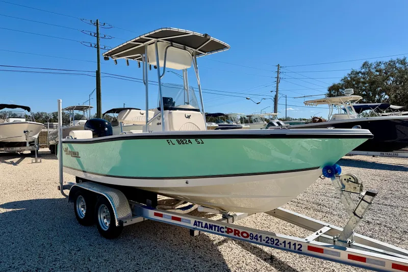 Slide: The Image of 2014 Mako 184 Center Console boat on trailer in sunny outdoor setting. - 3