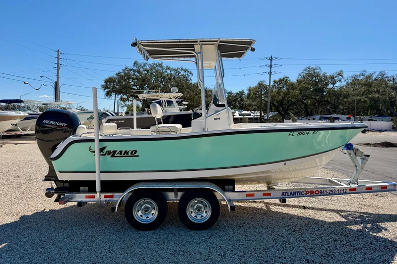 Slide: The Image of 2014 Mako 184 Center Console boat on trailer, parked outdoors. - 4