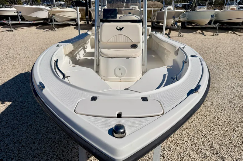 Slide: The Image of 2014 Mako 184 Center Console boat on display in a gravel lot. - 8