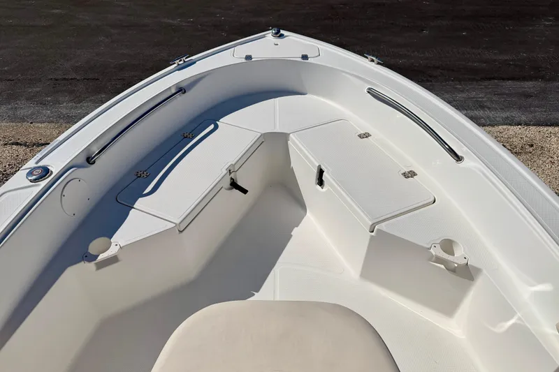 Slide: The Image of 2014 Mako 184 Center Console boat interior with storage compartments and seating. - 9