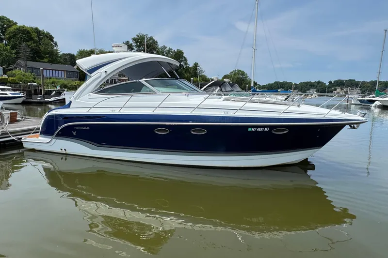 The Image of 2011 Formula 34 Performance Cruiser docked in a serene marina setting. - 0