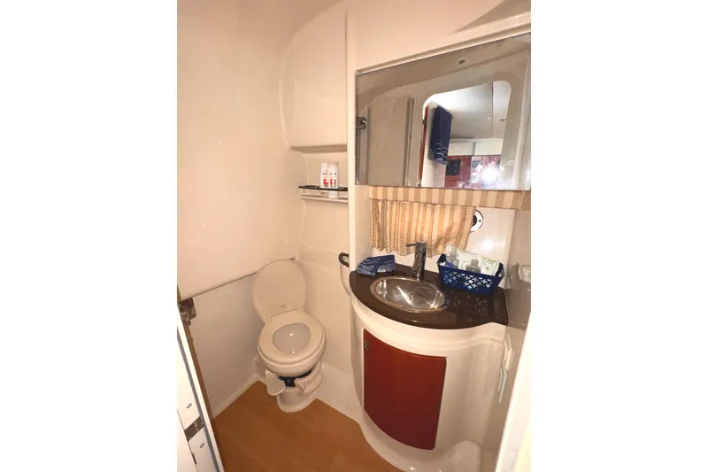 Slide: The Image of 2011 Formula 34 Performance Cruiser bathroom with sink, toilet, and mirror. - 12