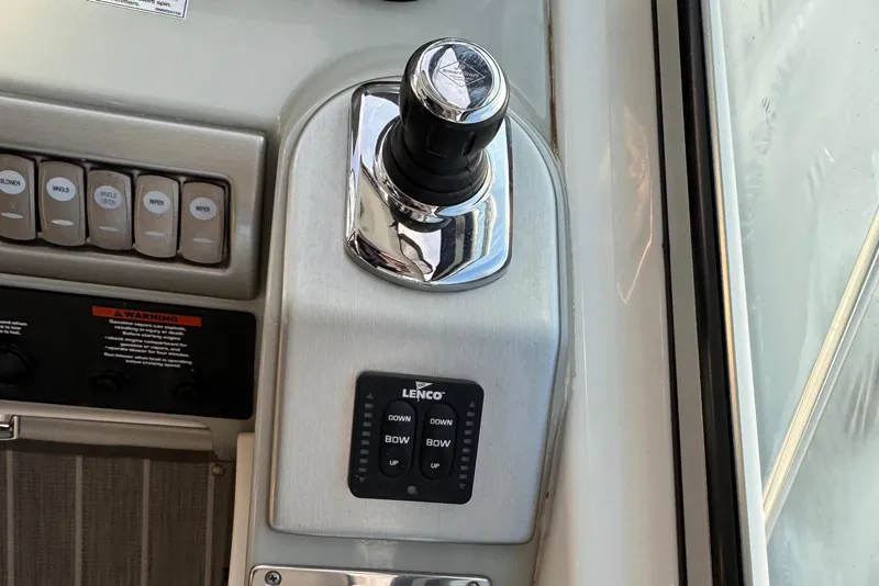 Slide: The Image of Control panel of a 2011 Formula 34 Performance Cruiser with joystick and Lenco trim tab switches. - 22