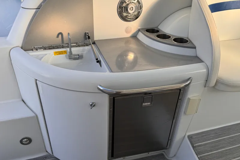 Slide: The Image of 2011 Formula 34 Performance Cruiser interior with sink, cup holders, and storage. - 26