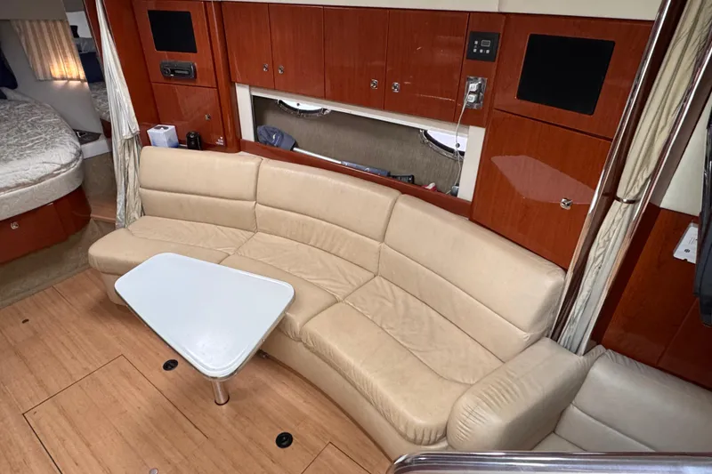 Slide: The Image of Interior of 2011 Formula 34 Performance Cruiser with beige seating and wooden cabinetry. - 5