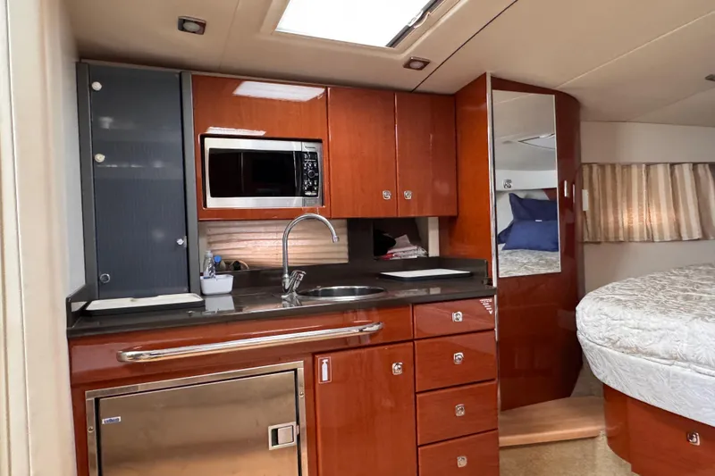 Slide: The Image of 2011 Formula 34 Performance Cruiser interior with kitchenette and cozy sleeping area. - 7