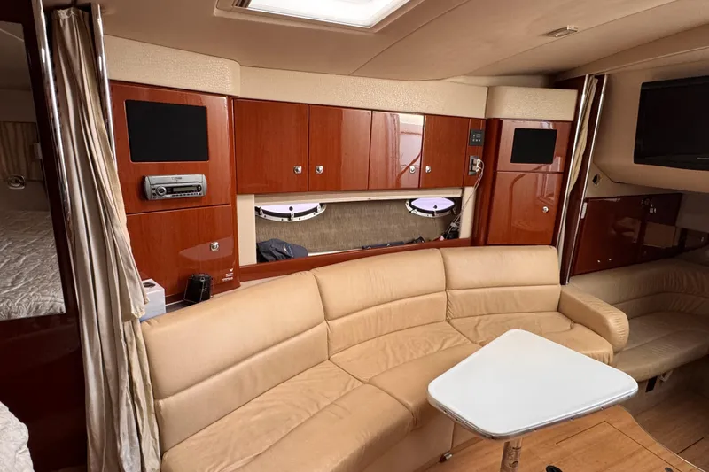 Slide: The Image of Luxurious interior of a 2011 Formula 34 Performance Cruiser with beige seating and wood cabinetry. - 9
