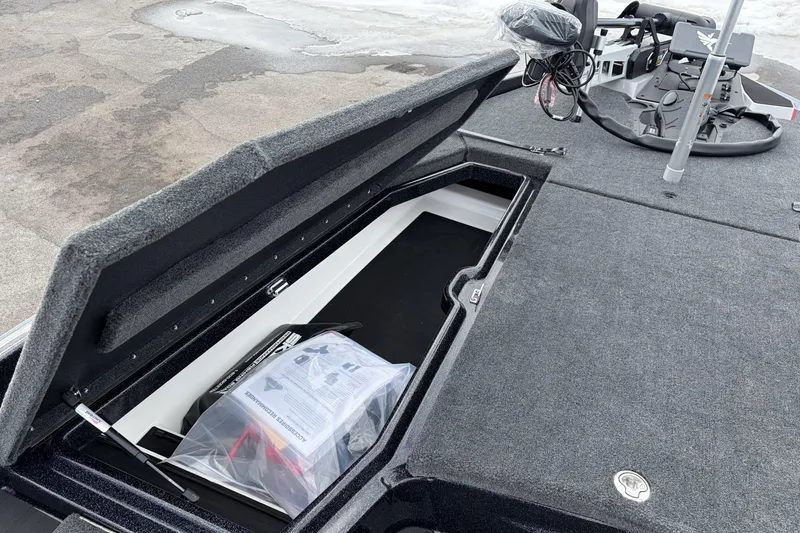 Slide: The Image of Open storage compartment on a 2026 Skeeter ZXE20 boat, showcasing interior space and equipment. - 15