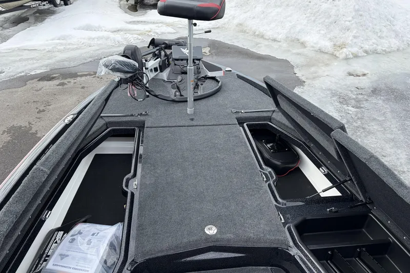 Slide: The Image of 2026 Skeeter ZXE20 boat deck with storage compartments, snowy background. - 17