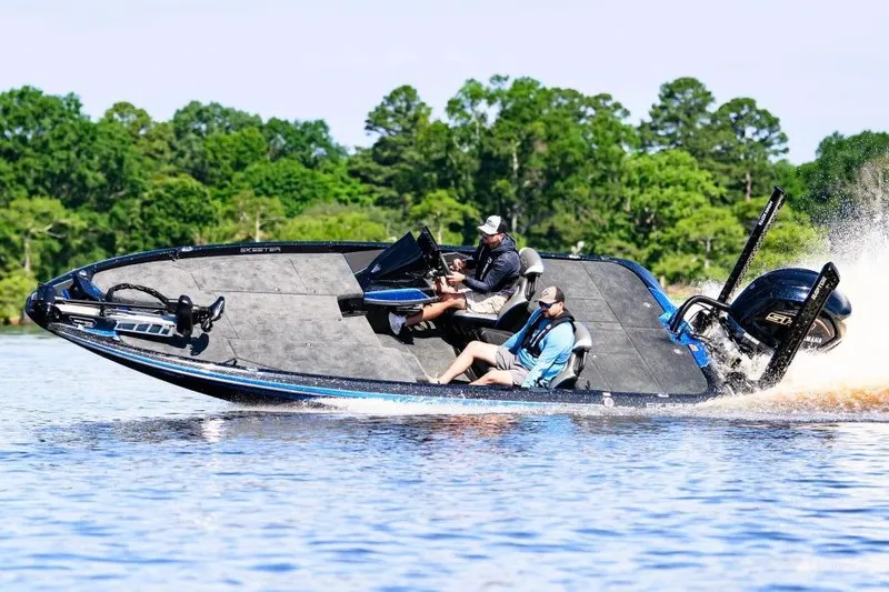 Slide: The Image of 2026 Skeeter ZXE20 boat with Minn Kota motor, parked outdoors on a snowy day. - 2