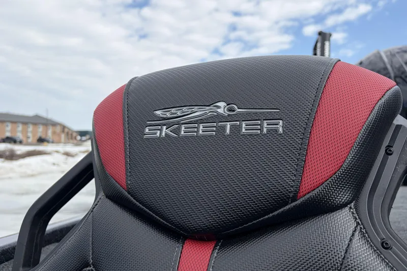 Slide: The Image of 2026 Skeeter ZXE20 boat seat with logo, featuring black and red design. - 20