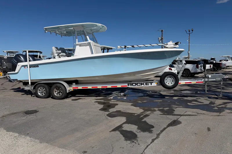 The Image of 2019 Contender 28 Tournament boat on trailer, parked outdoors under clear blue sky. - 0