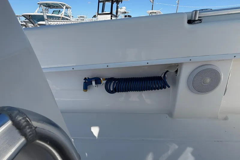 Slide: The Image of 2019 Contender 28 Tournament boat interior with coiled hose and speaker. - 13