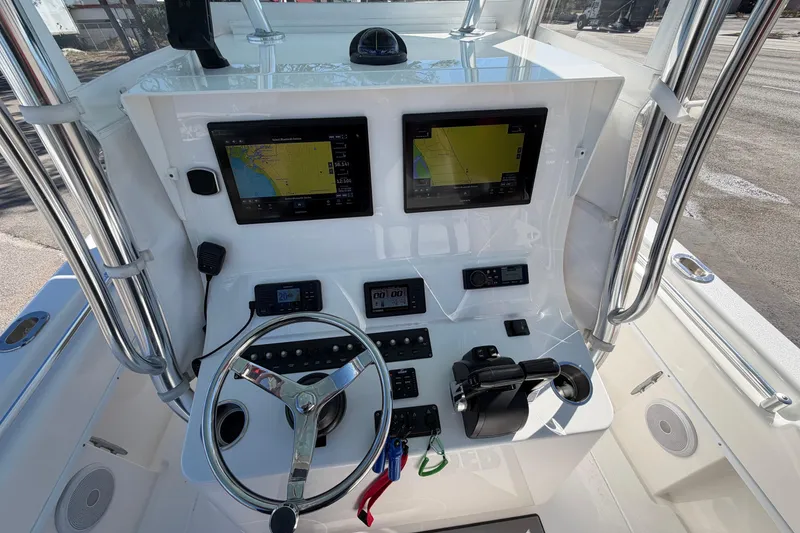 Slide: The Image of 2019 Contender 28 Tournament boat dashboard with navigation screens and steering wheel. - 4