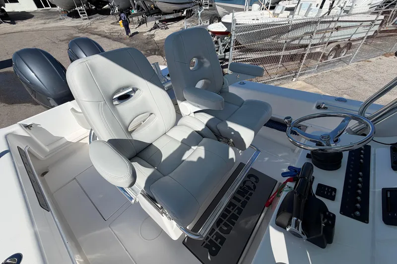 Slide: The Image of 2019 Contender 28 Tournament boat cockpit with dual helm seats and steering wheel. - 8