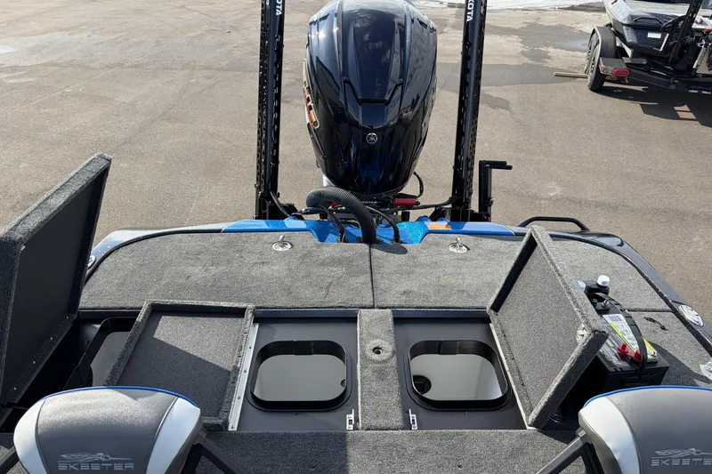 Slide: The Image of 2026 Skeeter ZXE21 boat with open storage compartments and powerful outboard motor. - 11