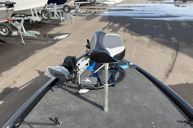 Slide: The Image of 2026 Skeeter ZXE21 boat with a modern seat and equipment on a trailer. - 13