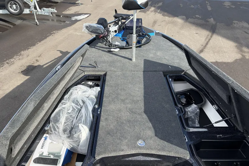 Slide: The Image of 2026 Skeeter ZXE21 boat interior with storage compartments and fishing seat. - 15