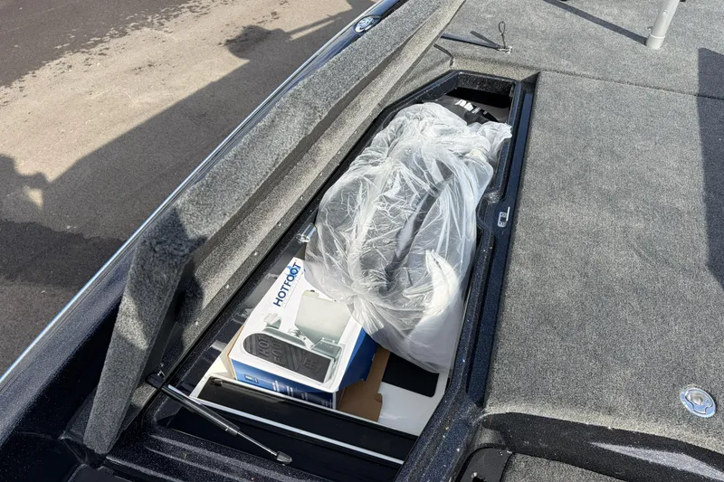 Slide: The Image of Storage compartment of 2026 Skeeter ZXE21 boat with packaged items inside. - 17