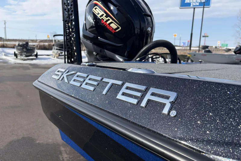 Slide: The Image of 2026 Skeeter ZXE21 boat with Yamaha VMAX engine, parked outdoors. - 21