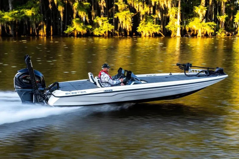 Slide: The Image of Manufacturer Provided Image: 2026 Skeeter ZXE21 boat speeding on a scenic lake with lush greenery. - 25
