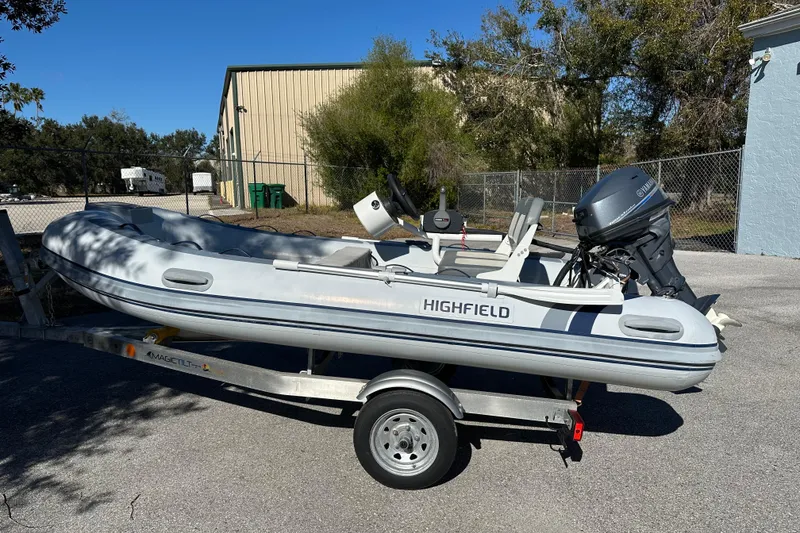 The Image of 2023 Highfield Classic 340 FCT inflatable boat on trailer, parked outdoors. - 0