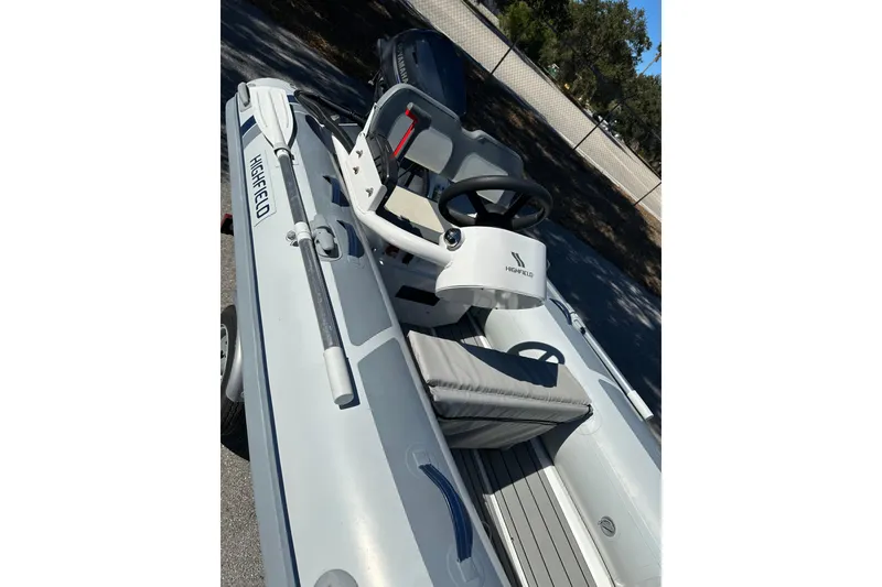 Slide: The Image of 2023 Highfield Classic 340 FCT inflatable boat with steering console and oars. - 8
