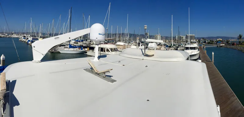 Slide: The Image of 1999 Bluewater 5800 yacht docked in marina, surrounded by boats. - 10