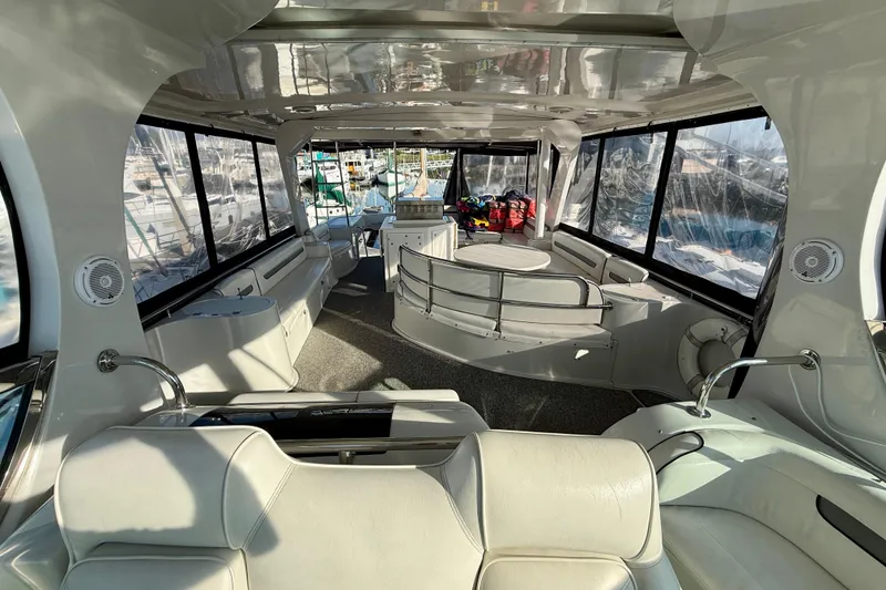 Slide: The Image of Interior of a 1999 Bluewater 5800 yacht with spacious seating and panoramic windows. - 11