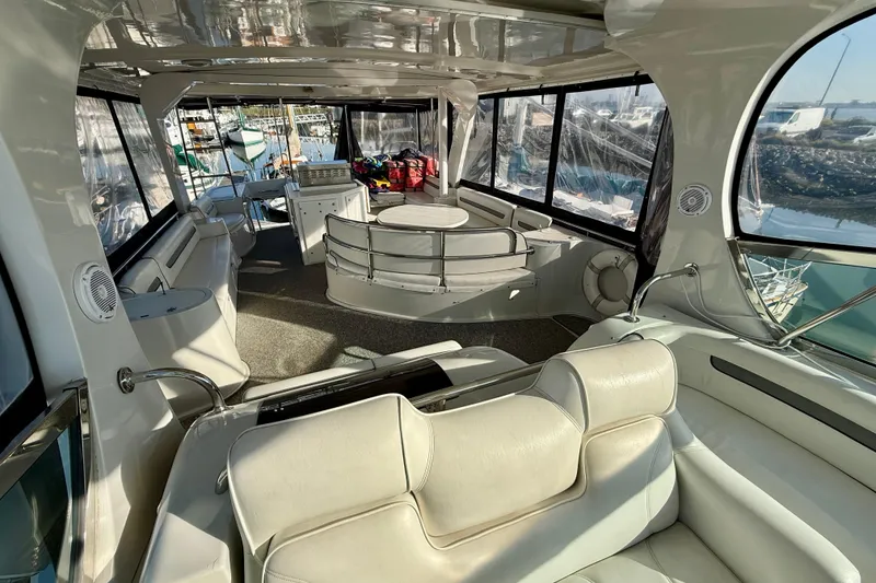 Slide: The Image of Luxurious interior of a 1999 Bluewater 5800 yacht with plush seating and panoramic windows. - 12