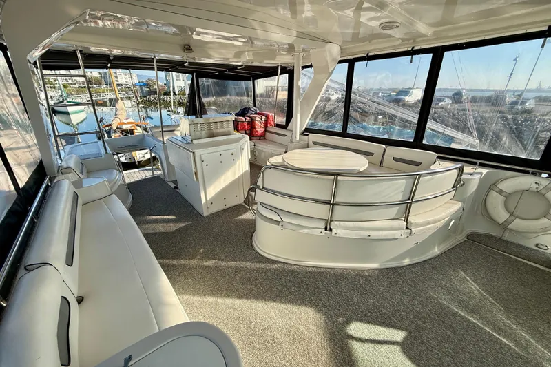 Slide: The Image of Luxurious 1999 Bluewater 5800 yacht interior with spacious seating and panoramic windows. - 14