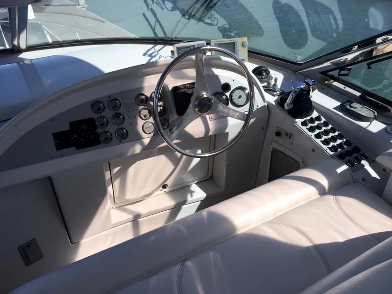 Slide: The Image of Interior of a 1999 Bluewater 5800 boat with steering console. - 16