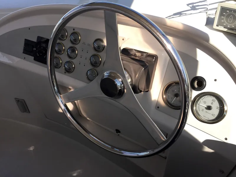 Slide: The Image of 1999 Bluewater 5800 helm with gauges and steering wheel. - 17