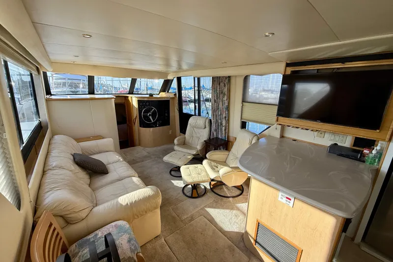 Slide: The Image of Luxurious interior of a 1999 Bluewater 5800 yacht with plush seating and modern amenities. - 20