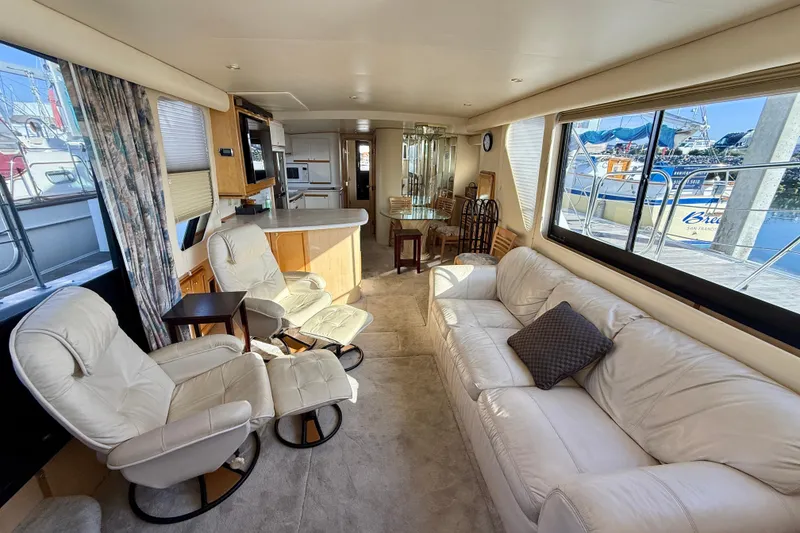 Slide: The Image of Luxurious interior of 1999 Bluewater 5800 yacht with plush seating and large windows. - 22