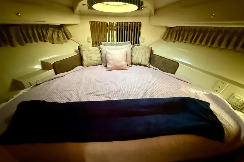 Slide: The Image of Cozy bedroom interior of 1999 Bluewater 5800 yacht with plush bedding and soft lighting. - 26