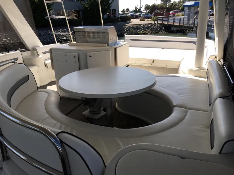 Slide: The Image of Interior of a 1999 Bluewater 5800 yacht with circular seating area. - 38