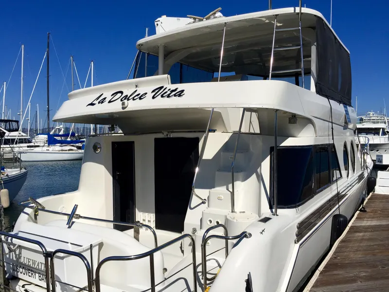 Slide: The Image of 1999 Bluewater 5800 yacht named "La Dolce Vita" docked at marina. - 4