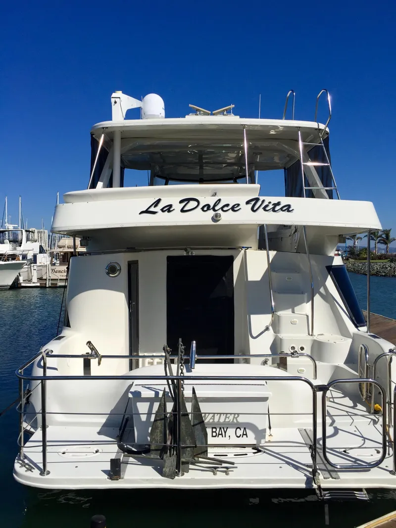 Slide: The Image of Rear view of 1999 Bluewater 5800 yacht docked in marina. - 5