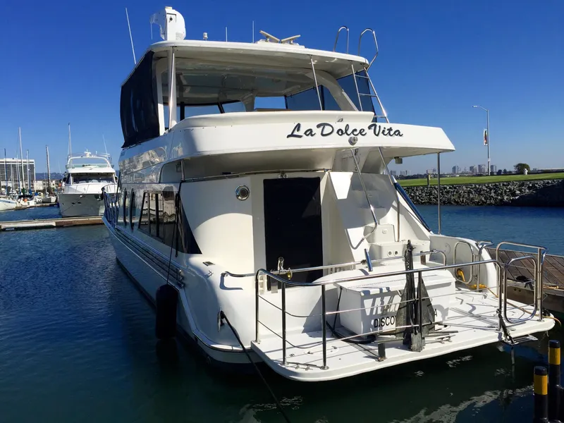 Slide: The Image of 1999 Bluewater 5800 yacht named 'La Dolce Vita' docked in harbor. - 6