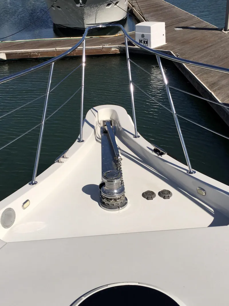 Slide: The Image of Bow view of a 1999 Bluewater 5800 yacht docked in marina. - 7
