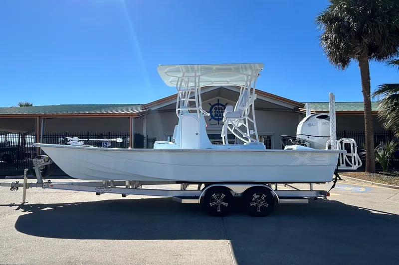 The Image of 2026 Shallow Sport 25 X3 boat on trailer, parked outdoors under clear blue sky. - 0