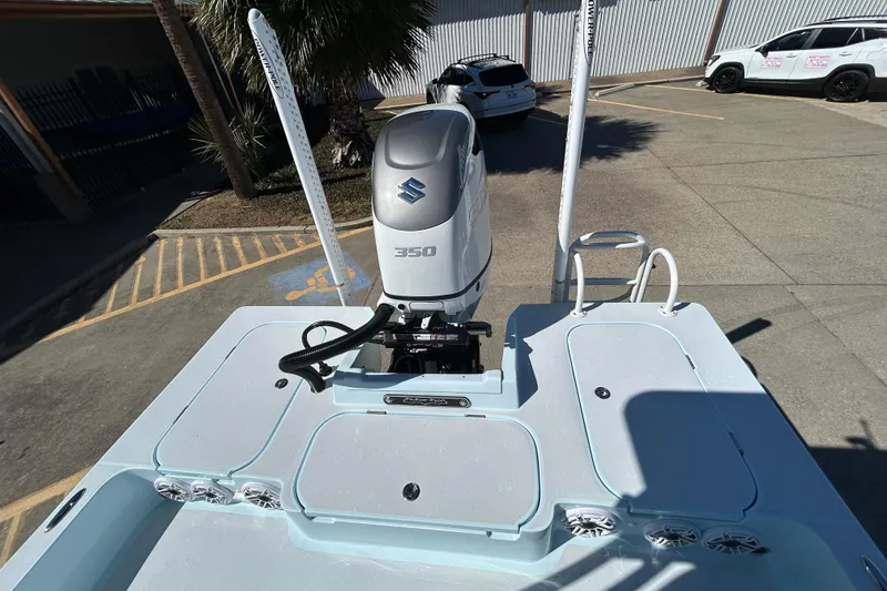 Slide: The Image of 2026 Shallow Sport 25 X3 boat with Suzuki 350 engine in a parking lot. - 14