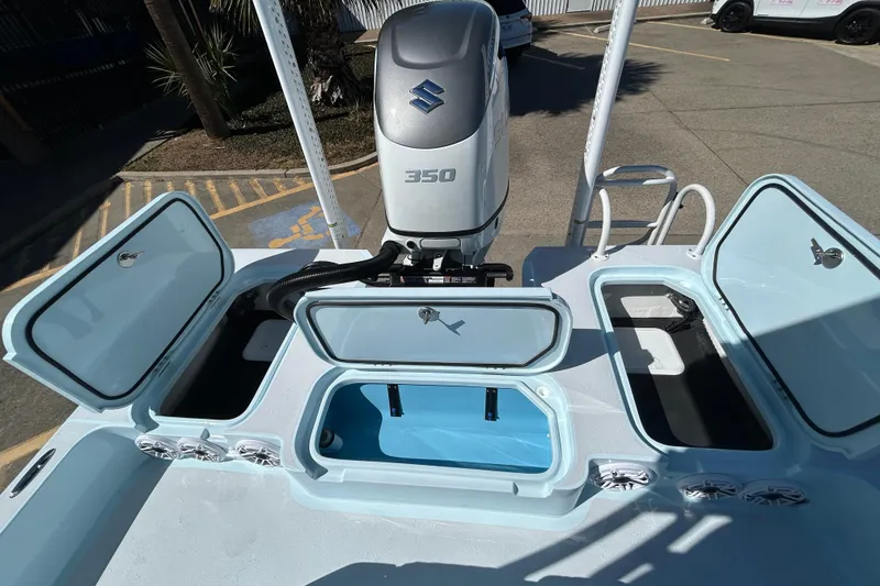 Slide: The Image of 2026 Shallow Sport 25 X3 boat with Suzuki 350 engine and open storage compartments. - 15