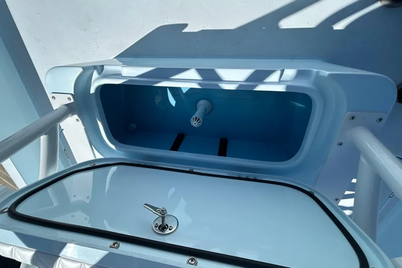 Slide: The Image of Livewell compartment on a 2026 Shallow Sport 25 X3 boat, open lid view. - 19