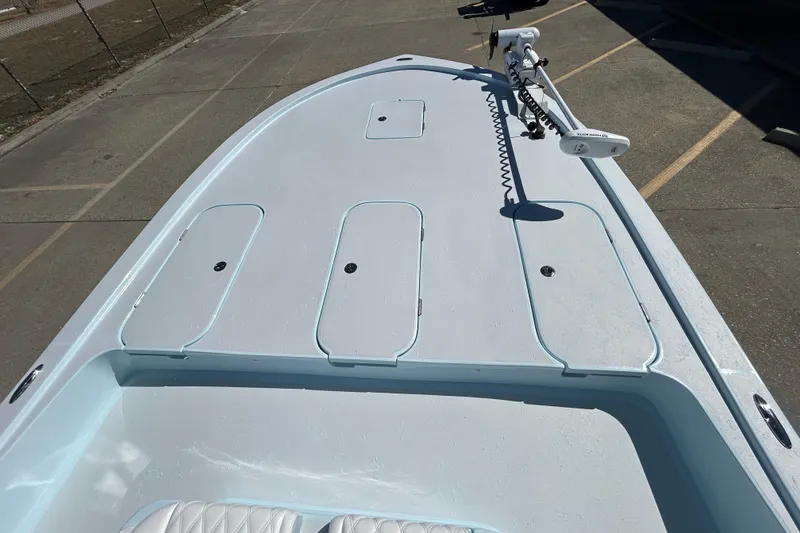 Slide: The Image of 2026 Shallow Sport 25 X3 boat deck with storage compartments and trolling motor. - 9