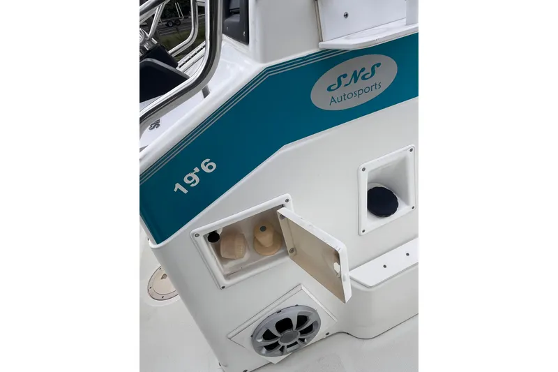 Slide: The Image of 1995 Wahoo 2100 EFS boat detail with SNS Autosports branding and storage compartments. - 11